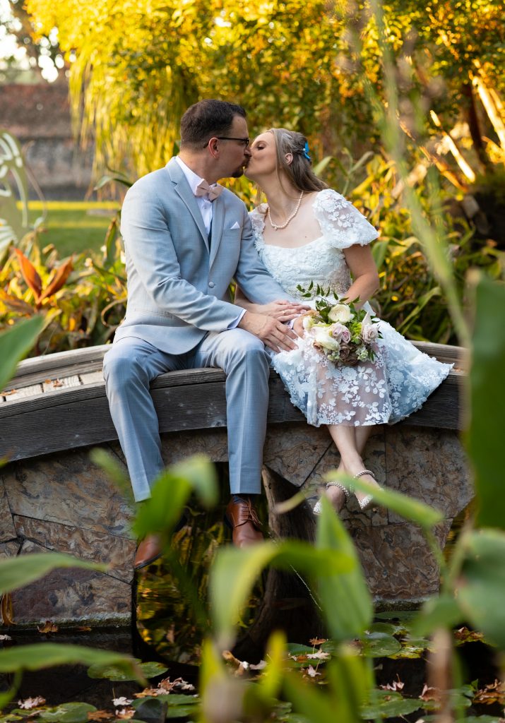 couple kissing on a bridge at a wedding
